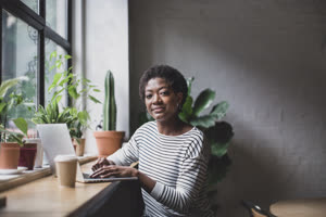Portrait of a freelance african american businesswoman working in a cafe