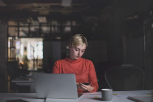 Young adult female working late in an office