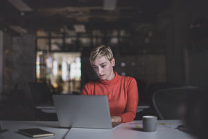 Young adult female working late in an office