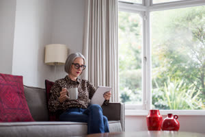 Mature adult female using a digital tablet