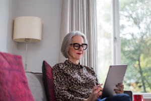 Mature adult female using a digital tablet