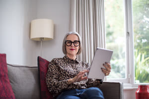 Portrait of a mature adult female with a digital tablet