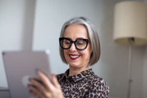 Mature adult female reading an ebook on a digital tablet