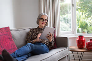 Mature adult female using a digital tablet