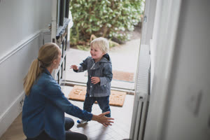 Child running to Mum in hallway