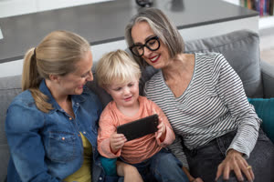 Three generations of family using a smartphone