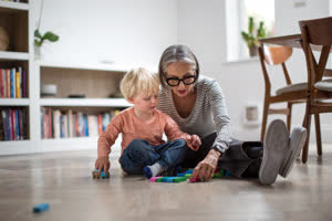 Grandson playing with grandmother at home