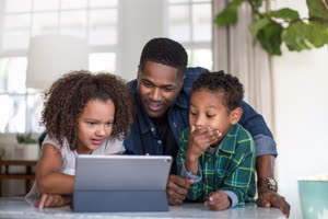 African American family using digital tablet together