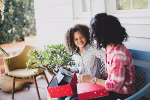 African American mother giving daughter a christmas gift