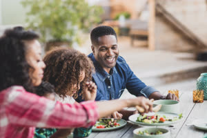 African American family having a family meal outdoors