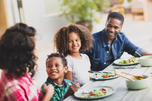 African American family having a family meal outdoors