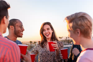 Group of friends gathering on a rooftop for a celebration