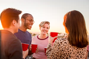 Group of friends gathering on a rooftop for a celebration