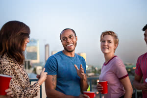 Group of friends dancing at a rooftop party