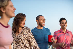 Group of friends dancing at a rooftop party