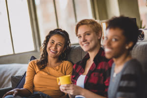 Young adult friends socialising in a loft apartment