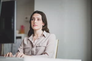 Female business executive working in an office on a desktop computer