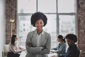 Portrait of African American businesswoman with her employees